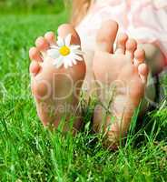 feet of a child with flower