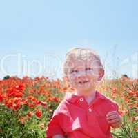 little baby boy posing on poppy fields