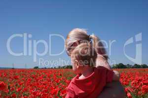 mom with her child in poppy field