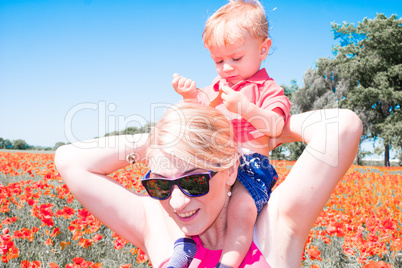 mom with her child in poppy field