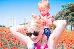 mom with her child in poppy field