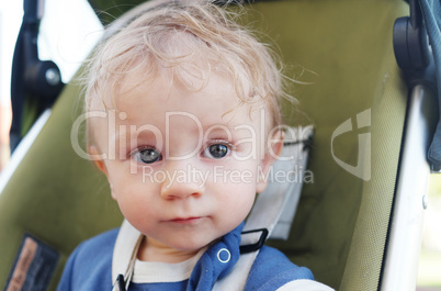 Close up Cute White Baby Boy on a Stroller