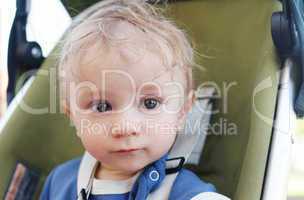 Close up Cute White Baby Boy on a Stroller