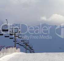 Snow skiing piste and ropeway at evening