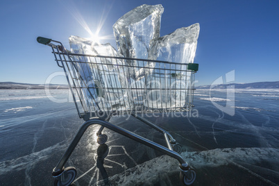 Shopping trolley full of clear ice on a frozen lake