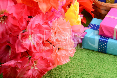 present gift box and flower bouquet on silk