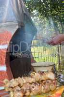 human hands roasting appetizing  barbecue from pork on the fire