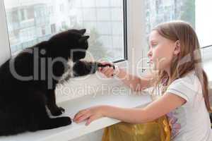 little girl associates with black cat