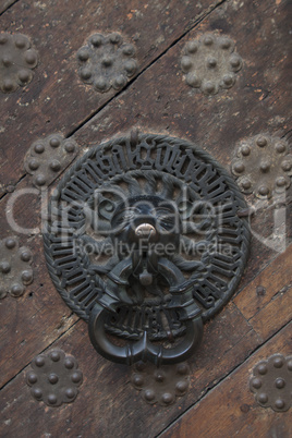 antique bell in centre of middle ages door