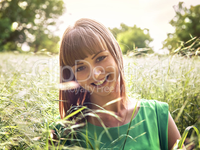 Young beautiful girl lying on the grass