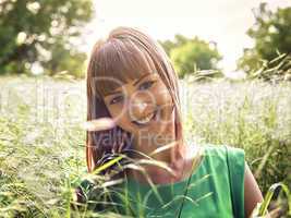 Young beautiful girl lying on the grass