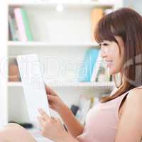 Asian female using touch screen tablet