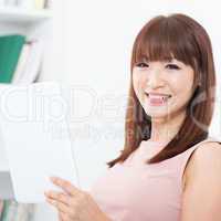 Asian woman using touch screen tablet