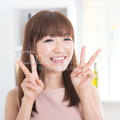 Asian girl showing v hands sign