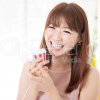 Asian girl eating cupcake