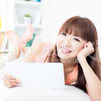 Asian girl relaxed and using tablet