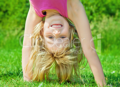 child stands upside down