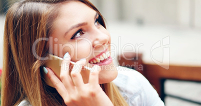 Pretty Woman Talking on Phone While at the Cafe