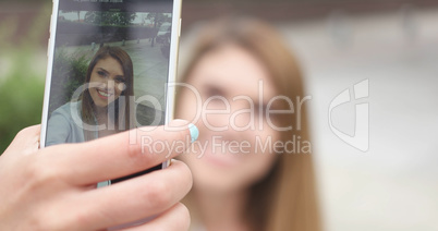 Young woman taking selfie on the street