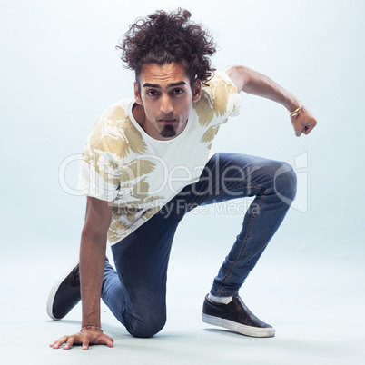 Young Male Hip Hop Dancer Kneeling on the Floor