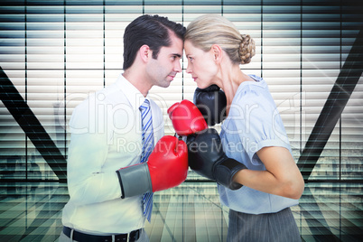 Composite image of business people wearing and boxing red gloves