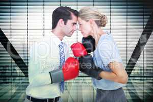 Composite image of business people wearing and boxing red gloves