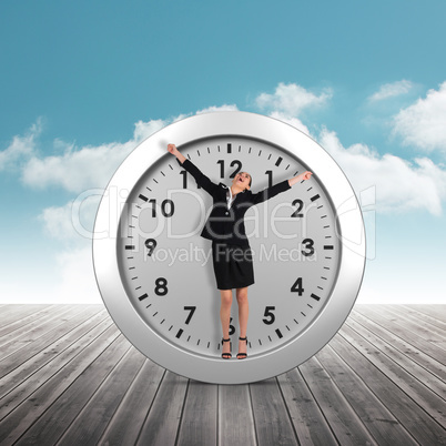 Composite image of excited businesswoman cheering