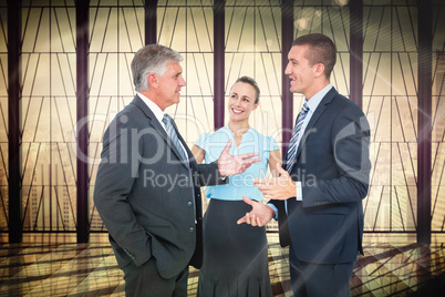 Composite image of business people standing and talking