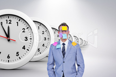 Composite image of businessman with post its on face