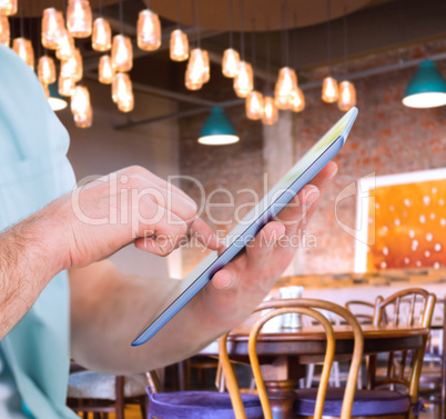 Composite image of man using tablet pc