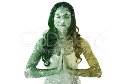 Composite image of pretty brunette doing yoga