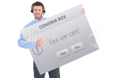 Composite image of businessman showing card wearing headset