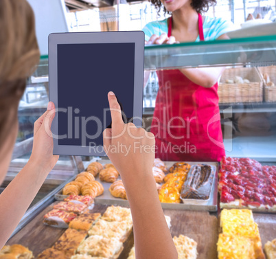 Composite image of woman using tablet pc