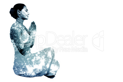 Composite image of content brunette in white sitting in lotus po