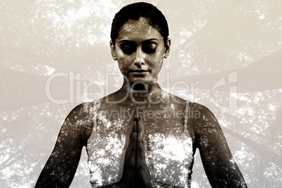 Composite image of peaceful woman in white sitting in lotus pose