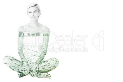 Composite image of smiling blonde woman sitting on the floor