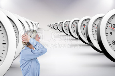 Composite image of businesswoman holding her head