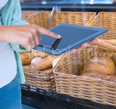 Composite image of woman using tablet pc