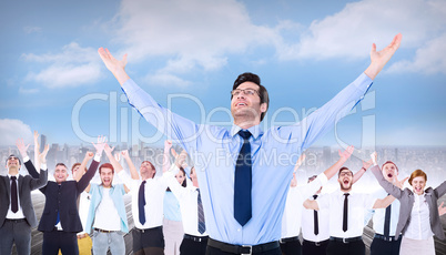 Composite image of cheering businessman with his arms raised up