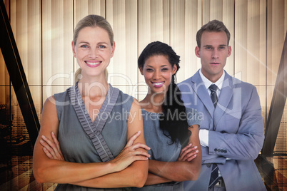 Composite image of happy business team smiling at camera