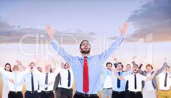 Composite image of happy cheering businessman raising his arms