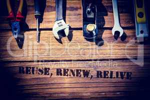 Reuse, renew, relive against desk with tools