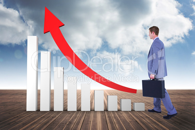 Composite image of handsome businessman holding a suitcase