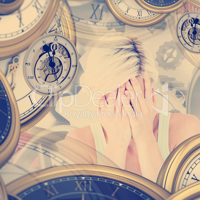 Composite image of sad blonde woman crying with head on hands