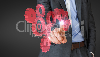 Composite image of businessman in grey suit pointing