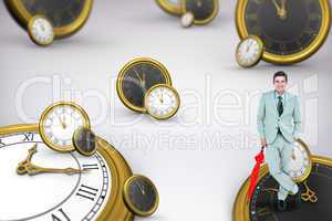 Composite image of smiling businessman with umbrella