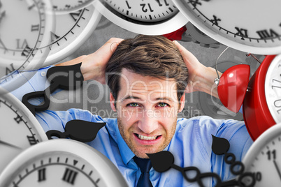 Composite image of stressed businessman with hands on head