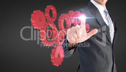 Composite image of businessman pointing with his finger