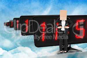 Composite image of businesswoman with box over head