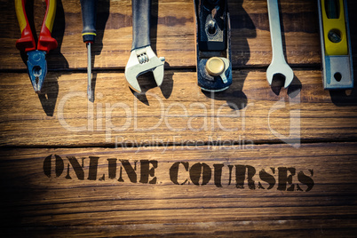 Online courses against desk with tools